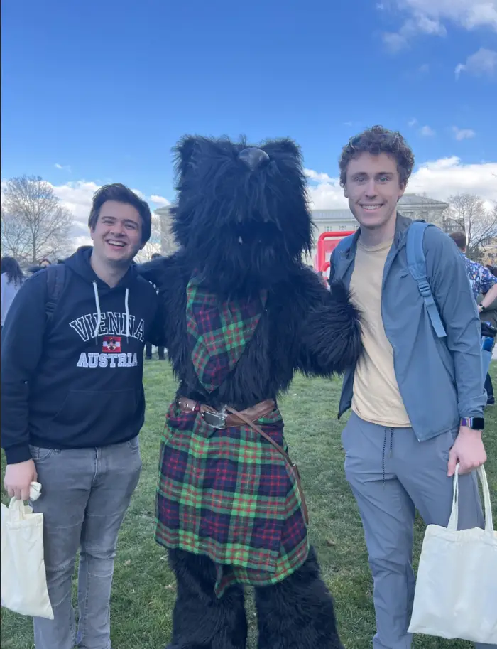 students posing with the scotty mascot