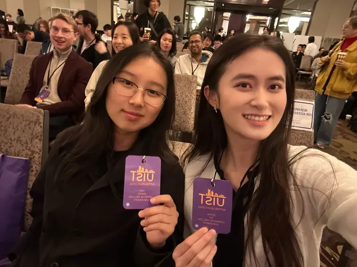Sofia and a peer at the UIST symposium.