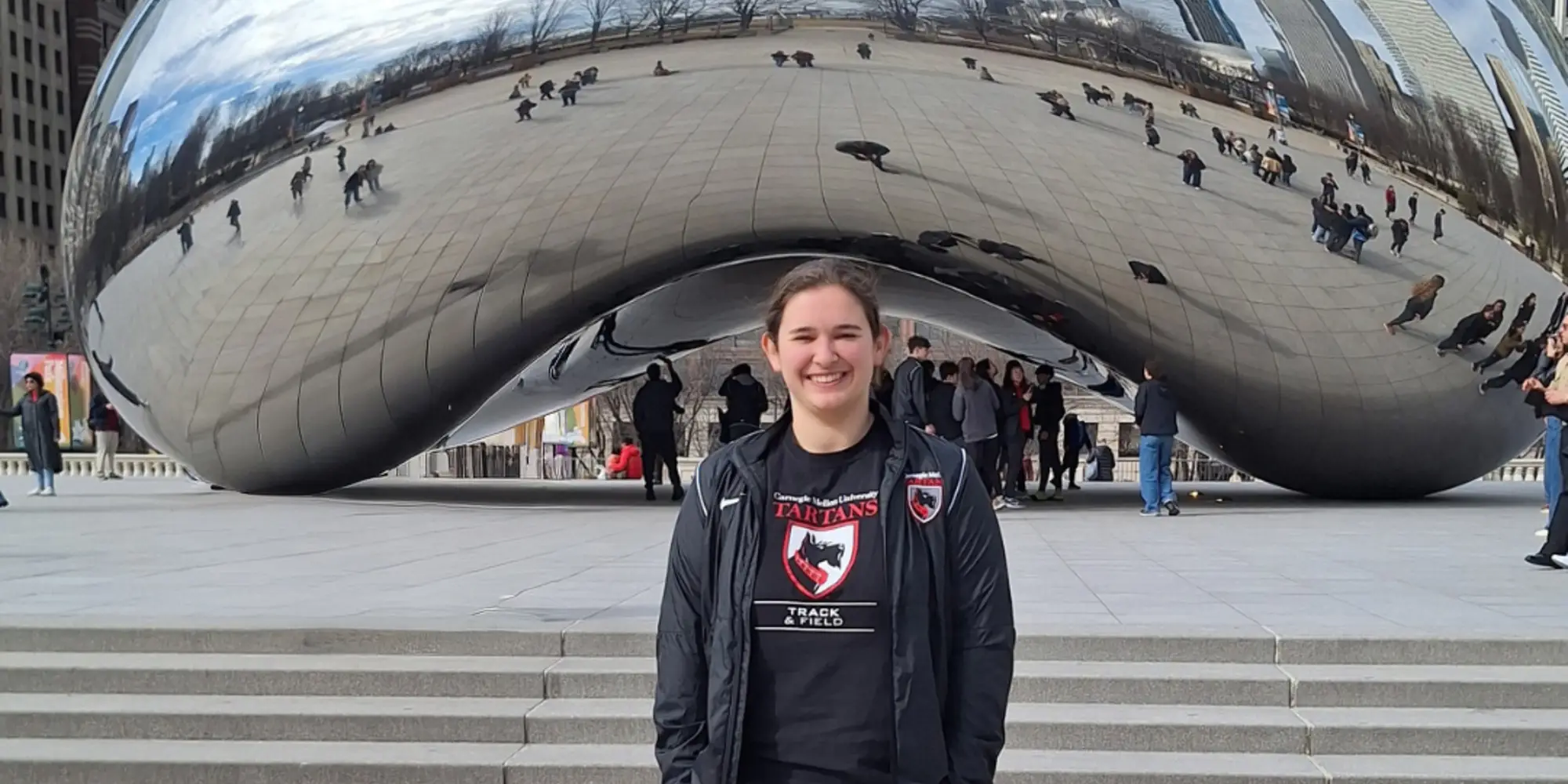 Katie smiling in front of the Bean in Chicago
