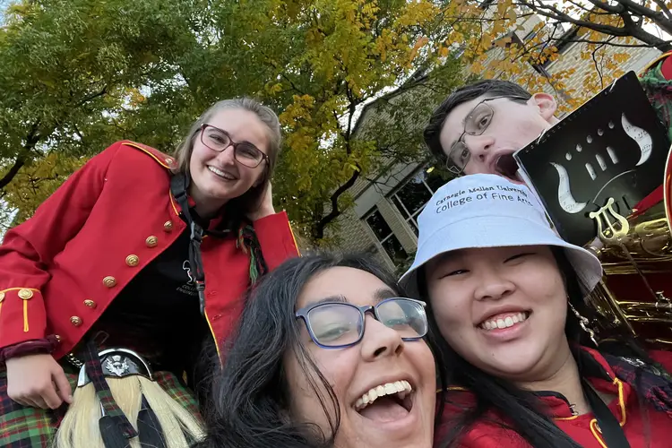 Bridget and friends smile for a photo during homecoming