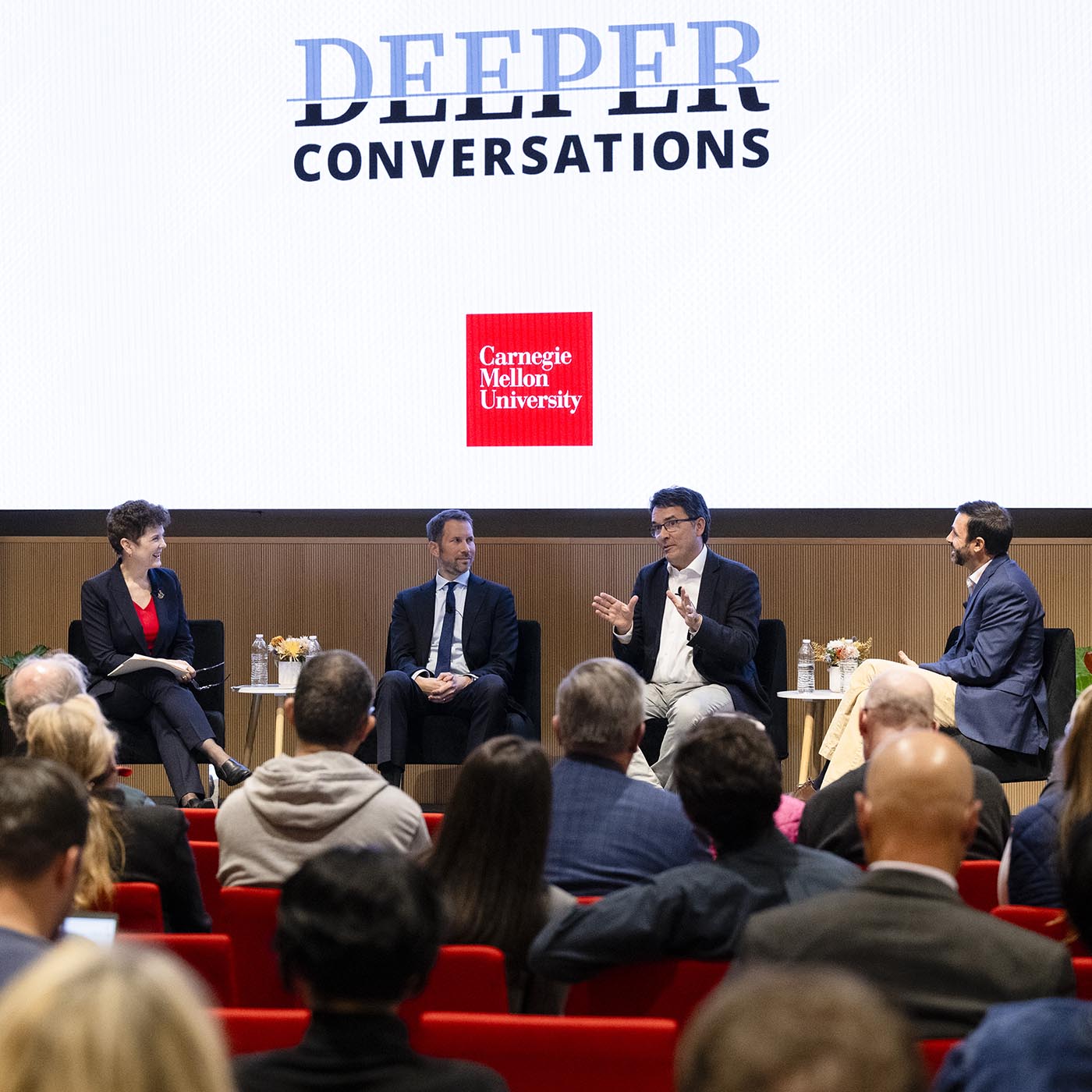 A panel on stage answering questions.