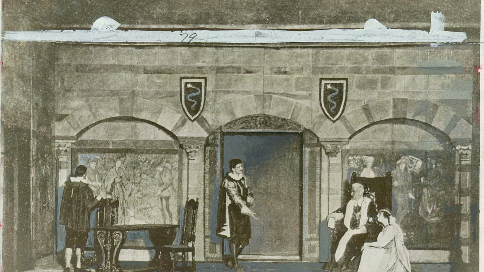 A muted theatrical set shows a stone hall with three arched bays, shield emblems, and a central doorway; costumed figures gather in a somber historical scene.